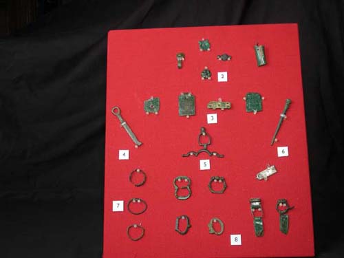 Various buckles, pins and small metal objects