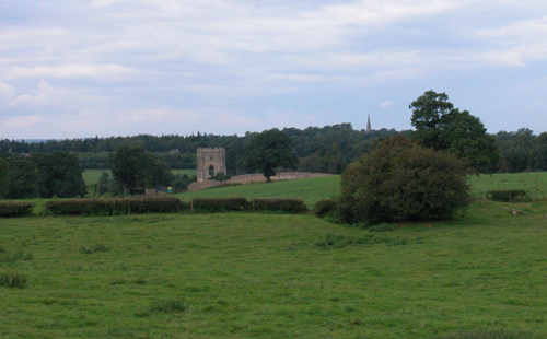 Fountains in its setting; remains of the abbey
              wall and Huby's tower