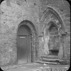 The entrance to the passageway or slype in the south east corner of the cloister and the walled up entrance to the warming house. The photograph seems to have been taken after the programme of conservation in 1892-6