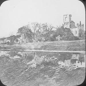 The ruins masked by trees and vegetation. View taken from the weir on the River Aire before 1892-6.