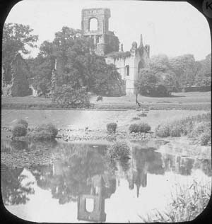 The ruins of Kirkstall Abbey ruins seen from the south east from a location below the weir. Photograph taken before the programme of conservation in 1892-6.